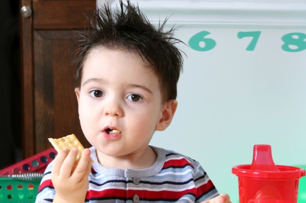 Little boy eating a cracker