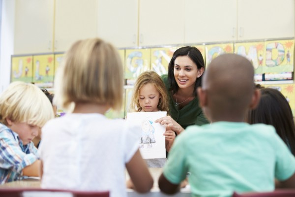 Student showing class a drawing