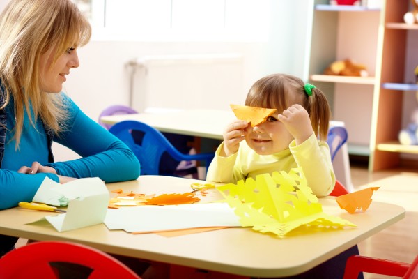 Girl playing with colored paper